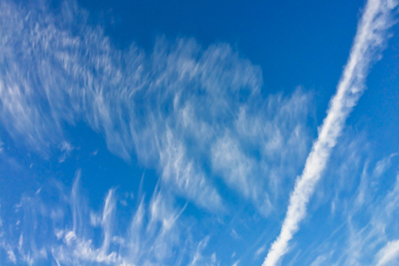 trail from the plane in the blue sky, beautiful clouds, blue skies, amazing skyの写真素材