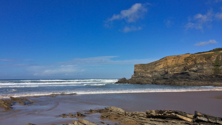 rocks on the ocean, seascape, beautiful sandy beach, clear blue sky, sunny weatherの写真素材