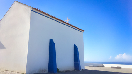 small white church in portugal on a sunny day, blue sky, combination of white and blue, place of prayer, religious buildingの写真素材
