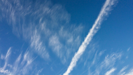trail from the plane in the blue sky, beautiful clouds, blue skies, amazing skyの写真素材