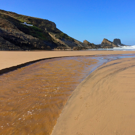 river flows into the ocean, stream flows to the sea, sandy river, beautiful seascapeの写真素材