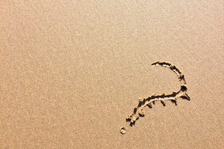 question mark drawn in the sand, a symbol of mystery and riddlesの写真素材