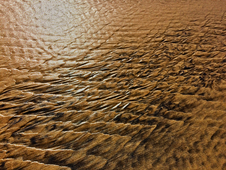 patterns created Ð¾n the sand by waves and wind, sand pattern as backgroundの写真素材