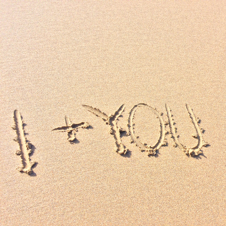 I plus you, the inscription on the sand, I and youの写真素材