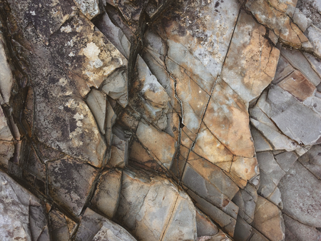 fractured rock strata as a background, cracked rock, stone texture, many cracks in the stone, fractured rockの写真素材