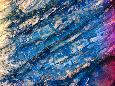 stone texture of amazing color, rocky layers of bright colorsの写真素材