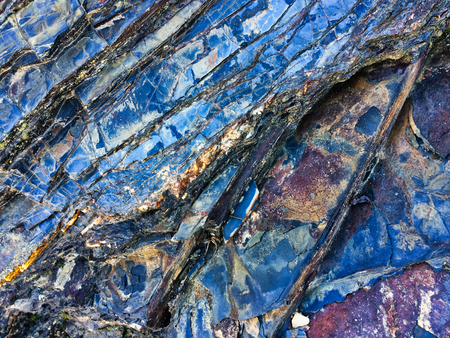 stone texture of amazing color, rocky layers of bright colorsの写真素材