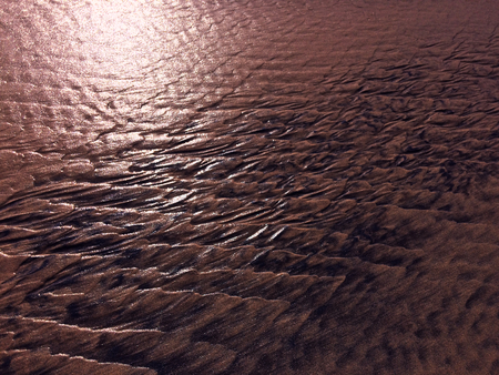 patterns created Ð¾n the sand by waves and wind, sand pattern as backgroundの写真素材