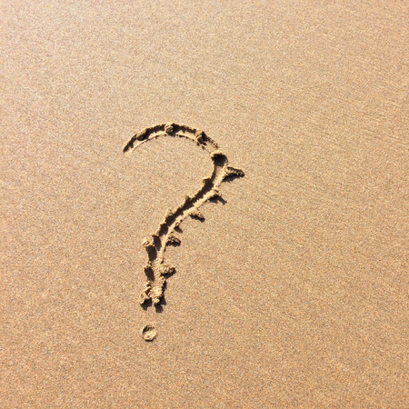 question mark drawn in the sand, a symbol of mystery and riddlesの写真素材