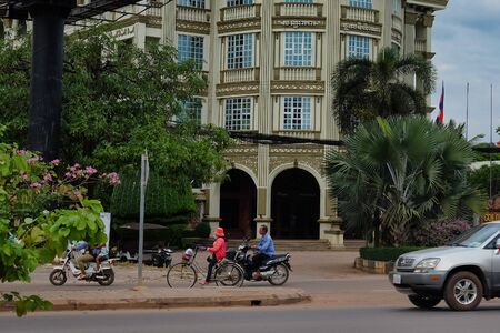 Cambodia, Siem Reap 12/08/2018 street traffic in an Asian city, tropical plants on the sidelines