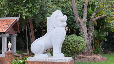 white statue of a lion, ornamental vegetation, Asian cultureの写真素材