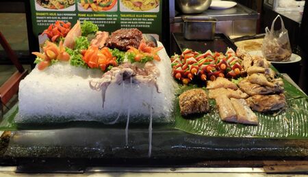 Siem Reap, Cambodia, December 11/2018 a large ice plate on which vegetables, meat, fish and octopuses lie, street foodのeditorial素材