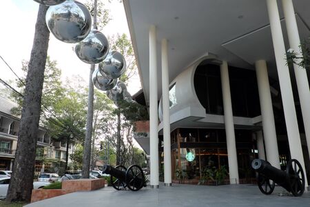 Siem Reap, Cambodia, December 12, 2018 two vintage cannons near the entrance to the Starbucks coffee house. The building is decorated with huge silver balls.のeditorial素材
