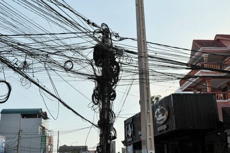 Siem Reap, Cambodia, December 17, 2018 power line pole with a huge number of wires. A dense network...