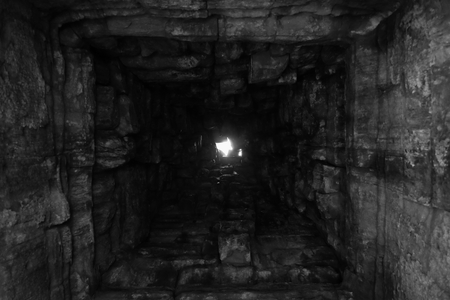 Deep well, the walls of which are lined with stone. Bottom view. Light at the end of the tunnel. Light at the end of the road. Background.の写真素材