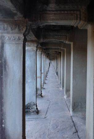 A long corridor with a colonnade. Old, abandoned building of the Khmer Empire.