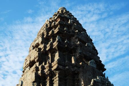 The upper part of one of the towers of the Angkor temple complex. The architectural art of the ancient Khmer.の写真素材