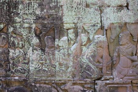 Medieval bas-relief on the wall of the Cambodian temple. The art of stone carving.の写真素材