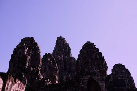 Monumental ancient temple of Bayon in Cambodia. Medieval temple in Indochina. Architectural art of ancient civilizations. Bayon temple in Angkor Thom. Face towers.の写真素材