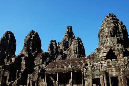 Monumental ancient temple of Bayon in Cambodia. Medieval temple in Indochina. Architectural art of ancient civilizations. Bayon temple in Angkor Thom. Face towers.の写真素材