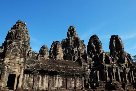 Monumental ancient temple of Bayon in Cambodia. Medieval temple in Indochina. Architectural art of ancient civilizations. Bayon temple in Angkor Thom. Face towers.の写真素材