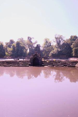 Ancient pool. The pool, the shore and the bottom of which are laid out of stone blocks. Neak Pean. Khmer baray.の写真素材