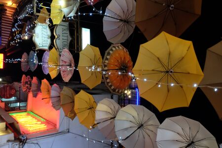 Siem Reap, Cambodia, December 23, 2018 multi-colored umbrellas are hung over the city street. Lots of hanging umbrellas. Night time.のeditorial素材