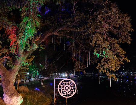 Light from street lamps reflects on the surface of the water at night. Night landscape.の写真素材