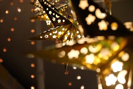 Decorative star-shaped lanterns suspended from the ceiling. Christmas garland.