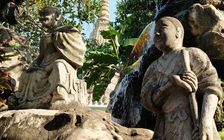 Ancient stone sculptures in the garden of a Buddhist monastery.の写真素材