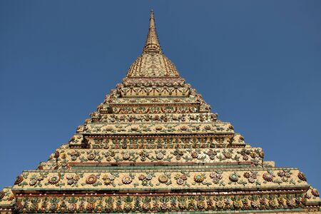 The towers of the ancient Buddhist monastery are decorated with colorful patterns.の写真素材