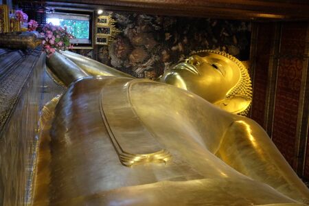 The world's largest sculpture of a reclining Buddha in a temple in Bangkok.の写真素材