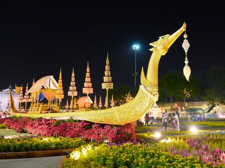 Bangkok, Thailand, December 27, 2018. A luxurious ceremonial boat of gold color is surrounded by flowers.のeditorial素材