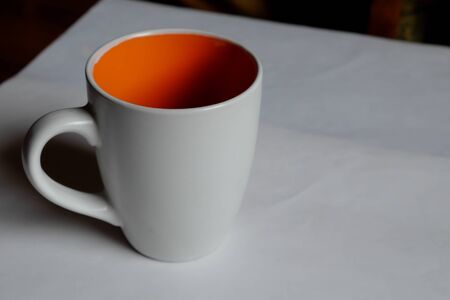 Empty white cup on a light background. Cup with place for text. Copyspace.の写真素材