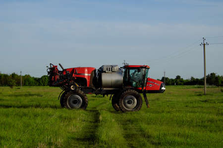 Chernihiv region, Ukraine, May 18, 2019. A tractor on high wheels designed for irrigation of fields. Agricultural machinery stands in the field.のeditorial素材