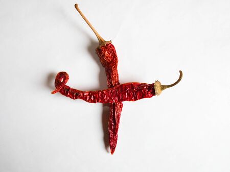 Sign + lined with red peppers on a white background.の写真素材