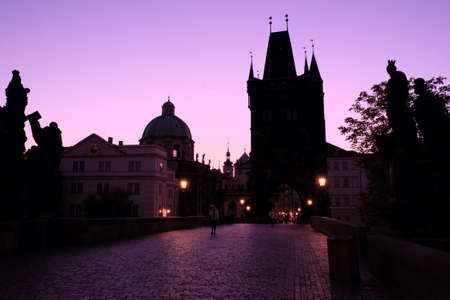 Prague, Czech Republic, October 13, 2019. Man on the Charles Bridge in Prague at dusk. Medieval European architecture.のeditorial素材