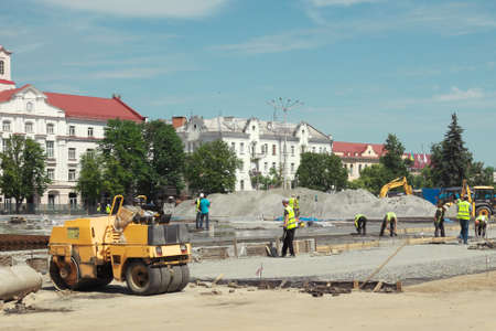 Chernihiv, Ukraine, June 7, 2019. Workers with the help of construction equipment change paving...
