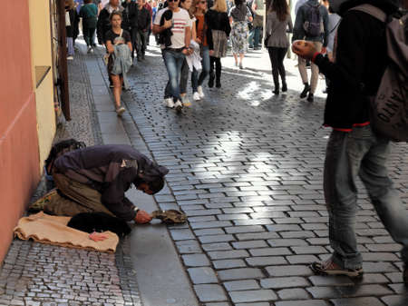 Prague, Czech Republic, October 12, 2019. A refugee kneeling asks for alms on a Prague street.のeditorial素材