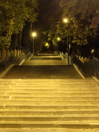 Staircase illuminated by street lamps. Street lighting.