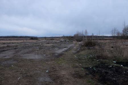 Chernihiv region, Ukraine, February 23, 2020. Meadow polluted with garbage. Gloomy landscape....