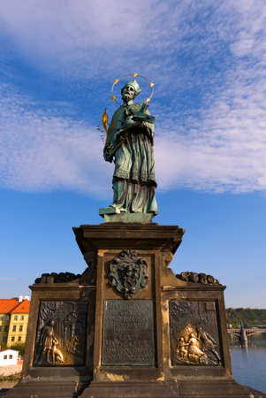 Statue of John of Nepomuk on Charles Bridge in Prague against the sky.のeditorial素材