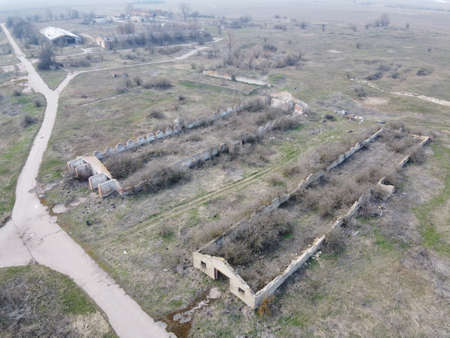 Destroyed agricultural buildings, aerial view. Abandoned livestock farm.の写真素材