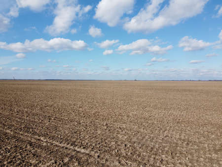 Beautiful blue sky over farm fields on a sunny day, aerial view. Landscape.