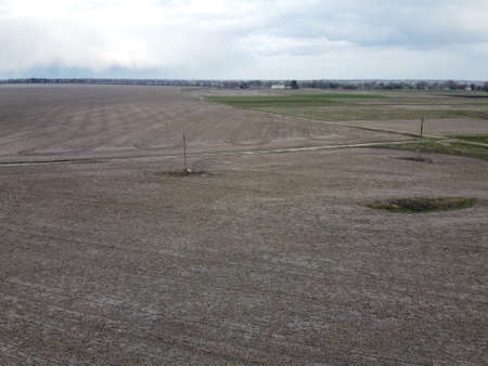 Dirt road among cultivated fields, aerial view. Agricultural field, arable land.