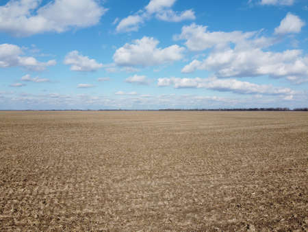 Beautiful blue sky over farm fields on a sunny day, aerial view. Landscape.