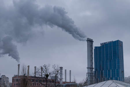 Kyiv, Ukraine, February 25, 2020. Chimneys near the office of the energy holding DTEK on a cloudy day. Samsung office.のeditorial素材