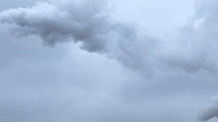 Puffs of gray smoke in the sky as a background. The sky is overcast.