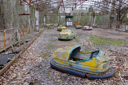 Cars in an abandoned amusement park in Pripyat. Rusty deserted attractions.の写真素材