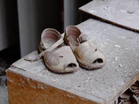 Small children's sandals in an abandoned kindergarten in Pripyat. Old children's shoes.の写真素材